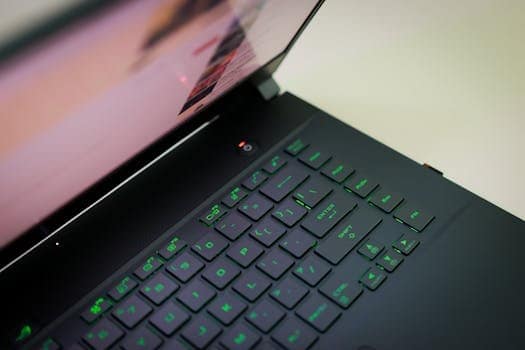 A sleek laptop with a glowing green keyboard illuminated, showcasing modern technology. Best Gaming Laptop for 2025: Top Picks for Every Gamer.