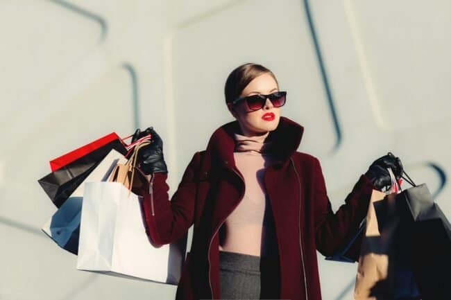 photo of woman holding white and black paper bags, Go Just Online