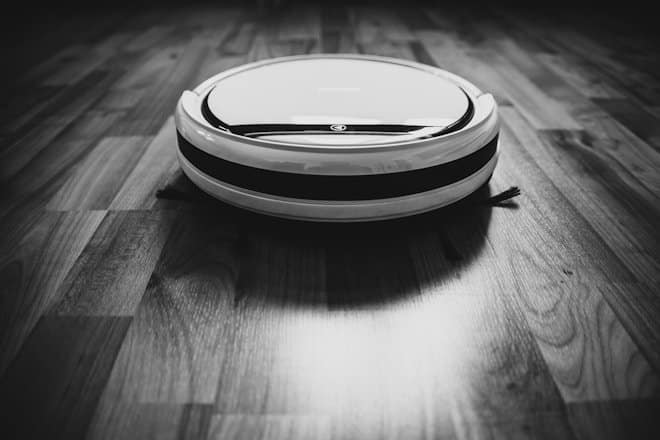 black and white round device. robotic vacuum cleaner