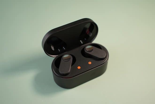 a black video game controller. best ear buds