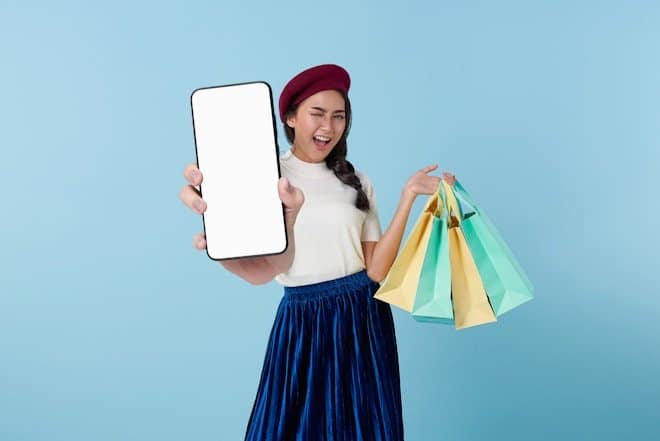A woman holding a tablet computer and shopping bags A woman holding a tablet computer and shopping bags