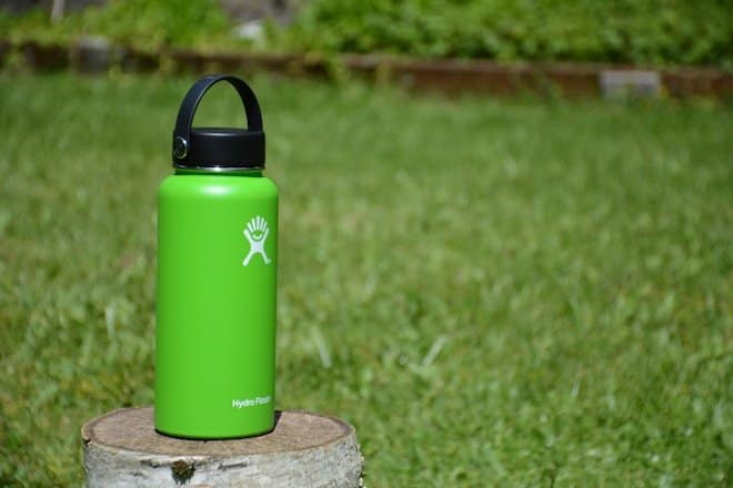 green Hydro Flask tumbler on wood slab green Hydro Flask tumbler on wood slab