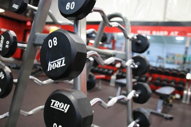 a gym filled with black and silver dumbs